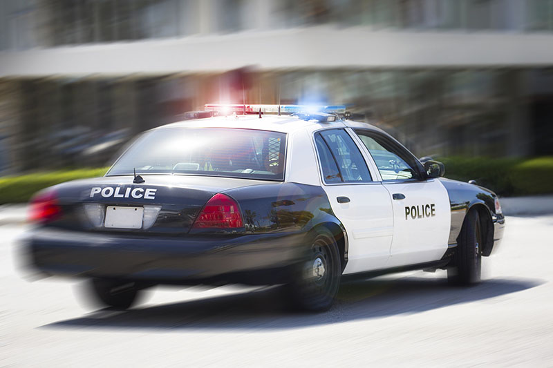 A police car races to the scene of an incident.